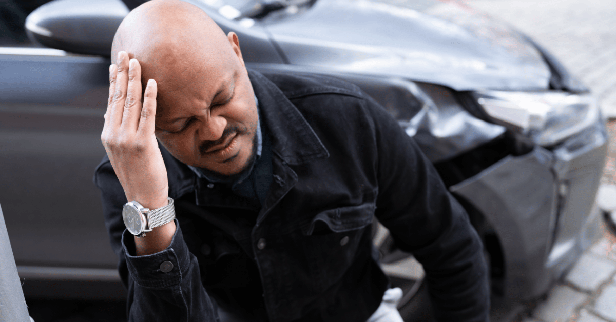 Male holding his head after a car accident injury